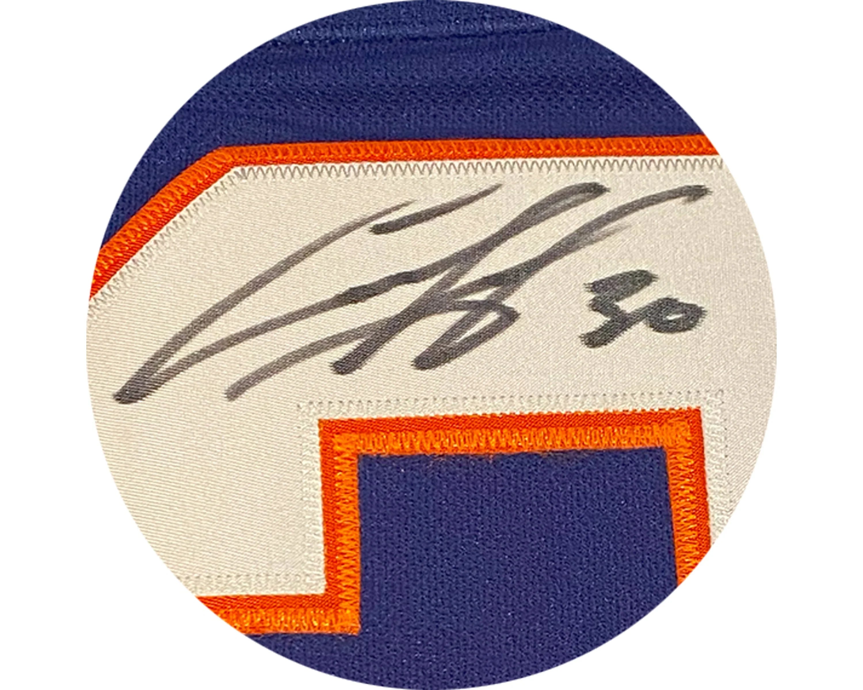 Close-up of signed New York Islanders jersey number patch with blue, orange, and white colors.