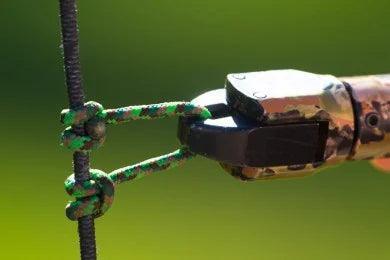 Camouflage release aid attached to a D-loop on a bowstring for archery installation