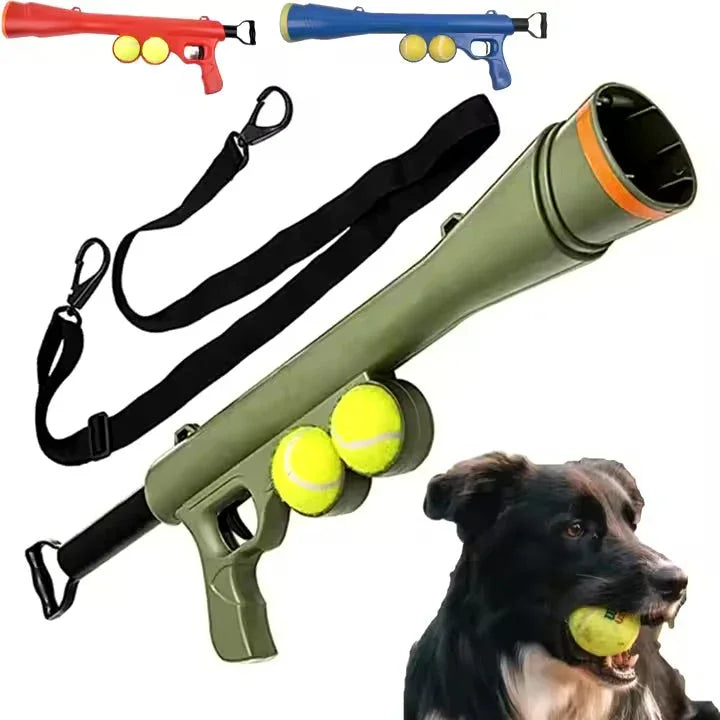 Dog ball launcher gun with tennis balls, strap, and a dog holding a ball in its mouth