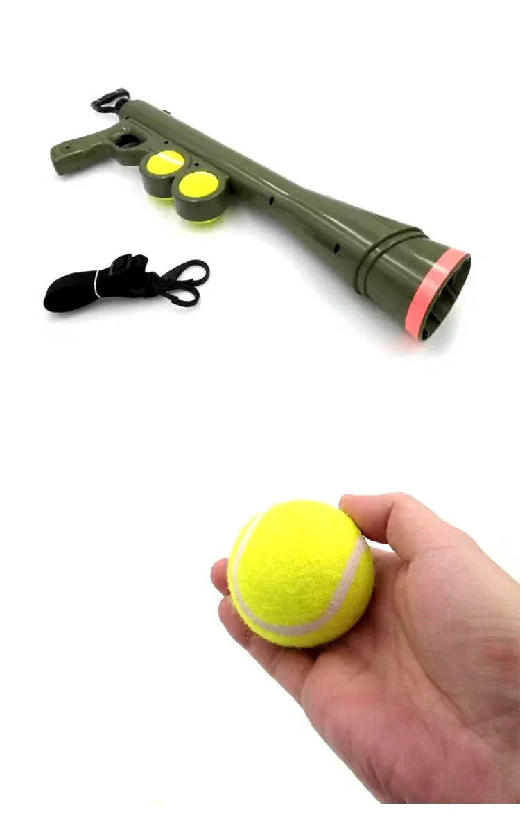 Green ball launcher gun with tennis balls and hand holding yellow tennis ball