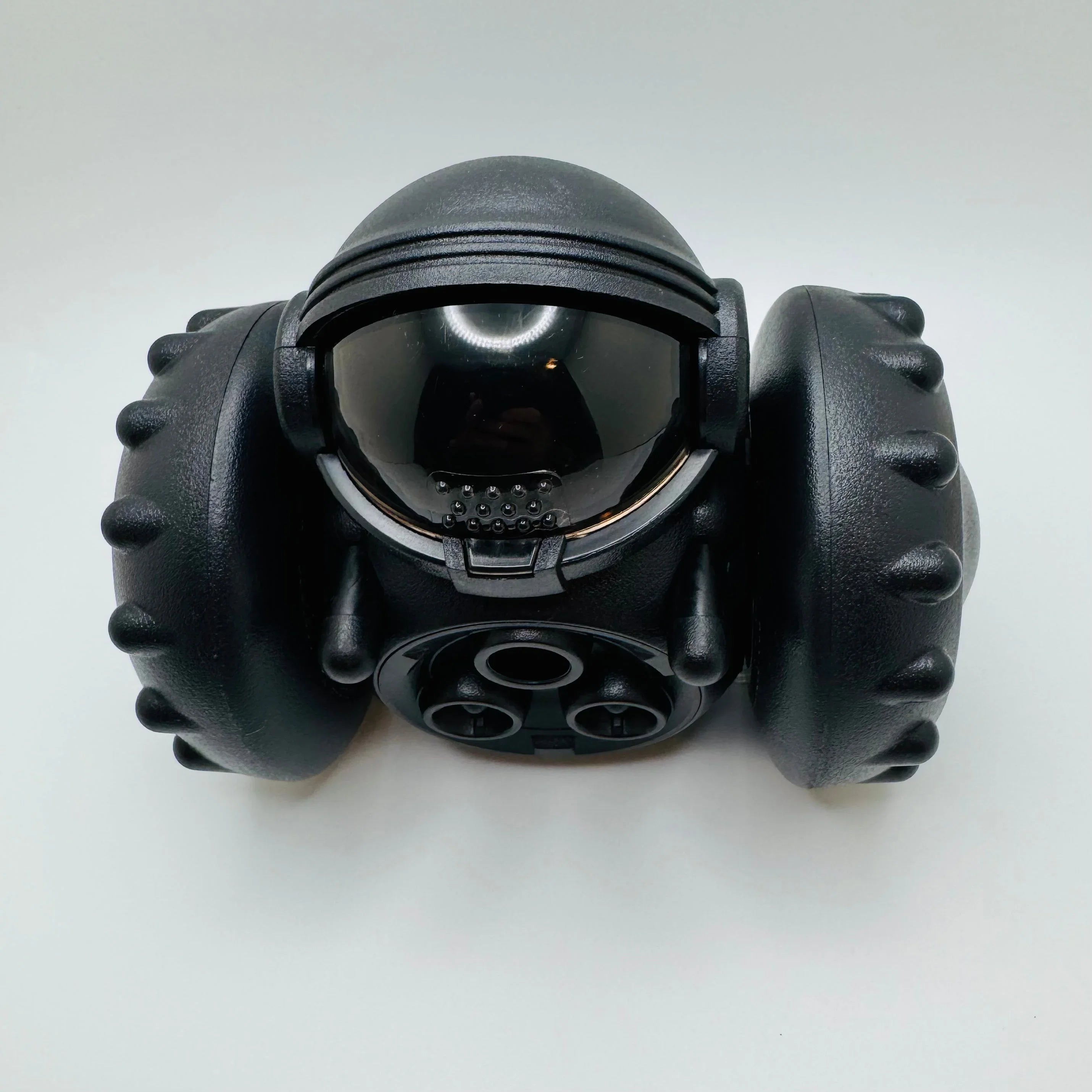 Black robotic toy car with large wheels and glossy visor on white background