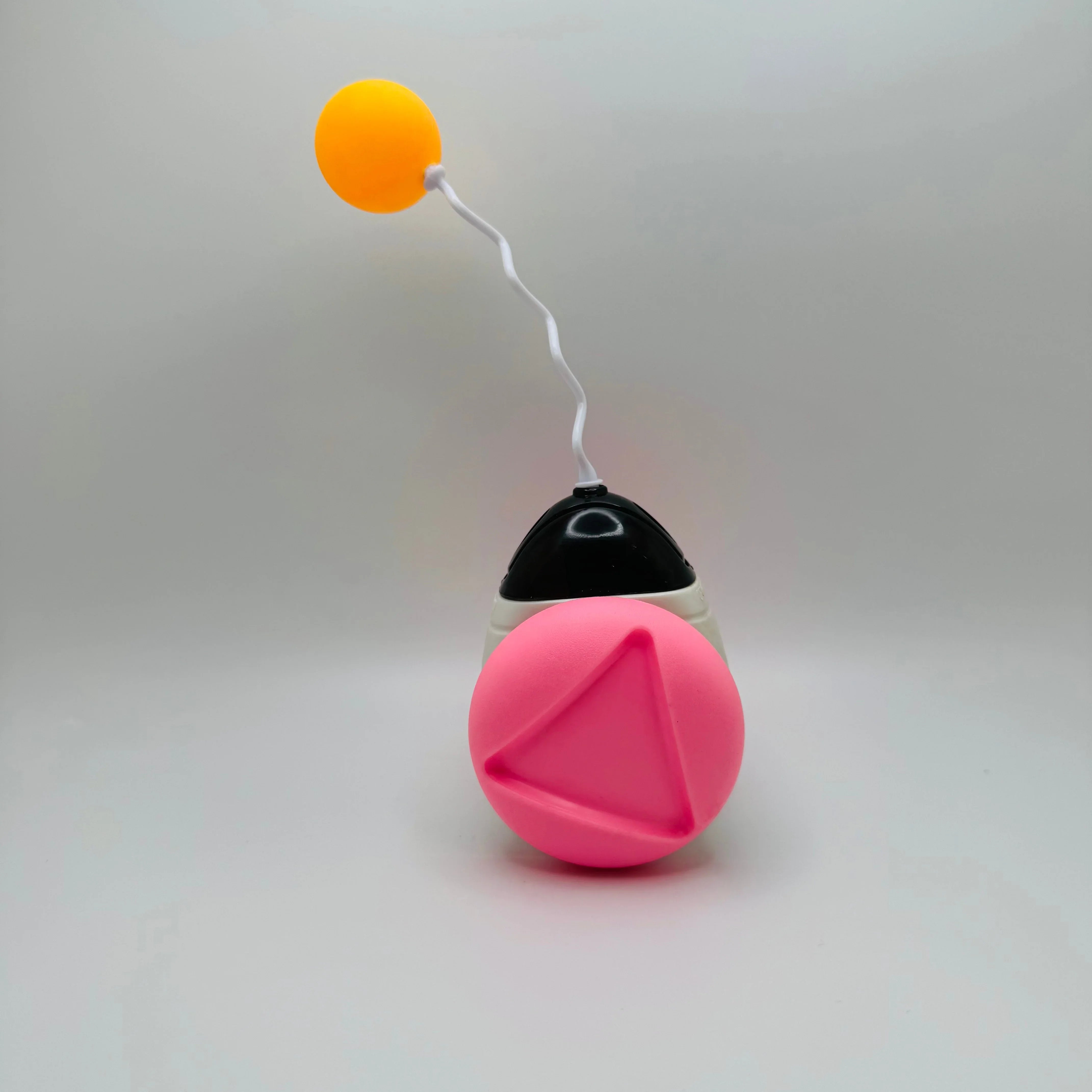 Interactive pet toy with pink and yellow balls on a white background for cats and dogs