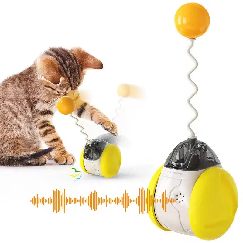 Tabby kitten playing with interactive yellow electronic cat toy on white background