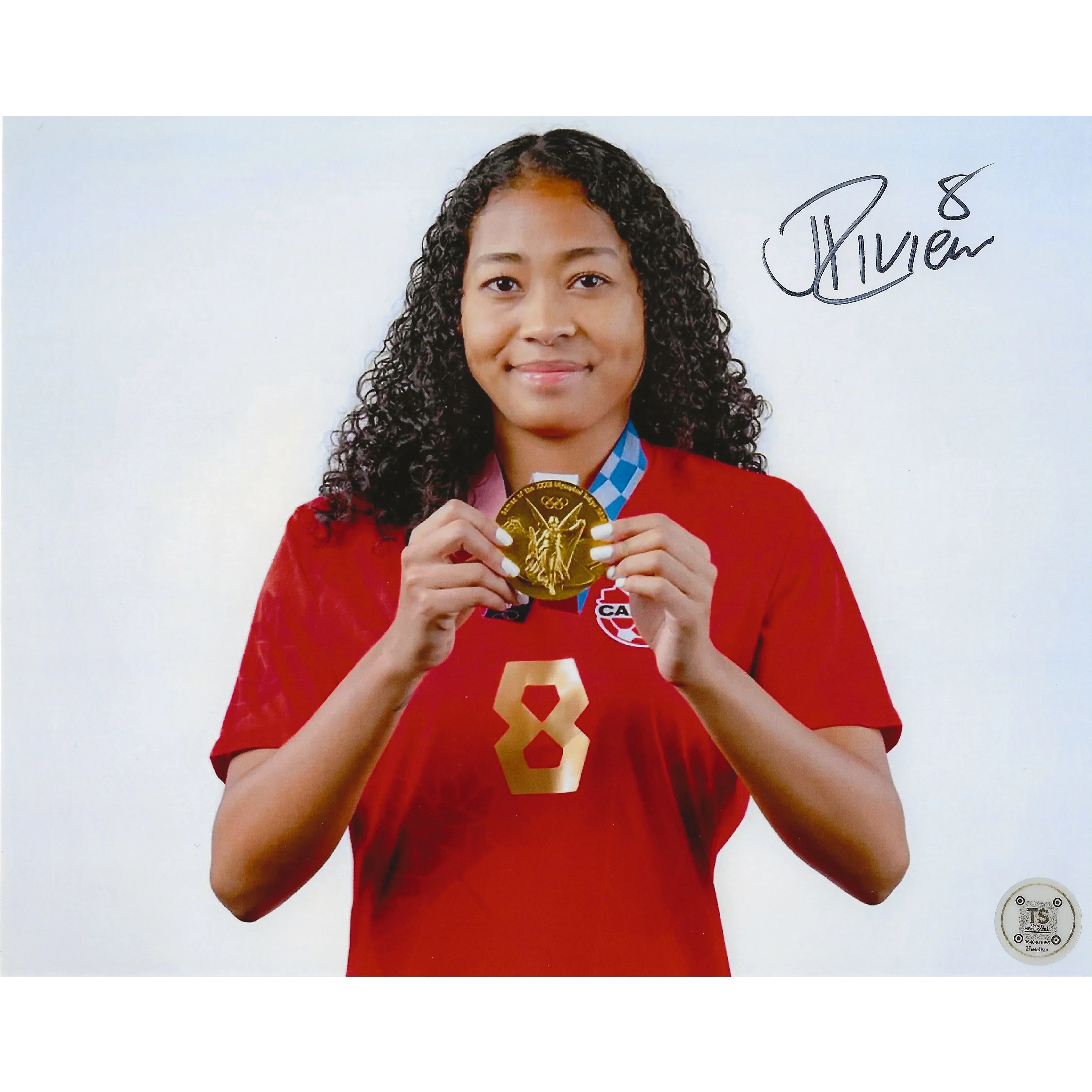 Female Canadian soccer player in red jersey holding Olympic gold medal, autographed photo