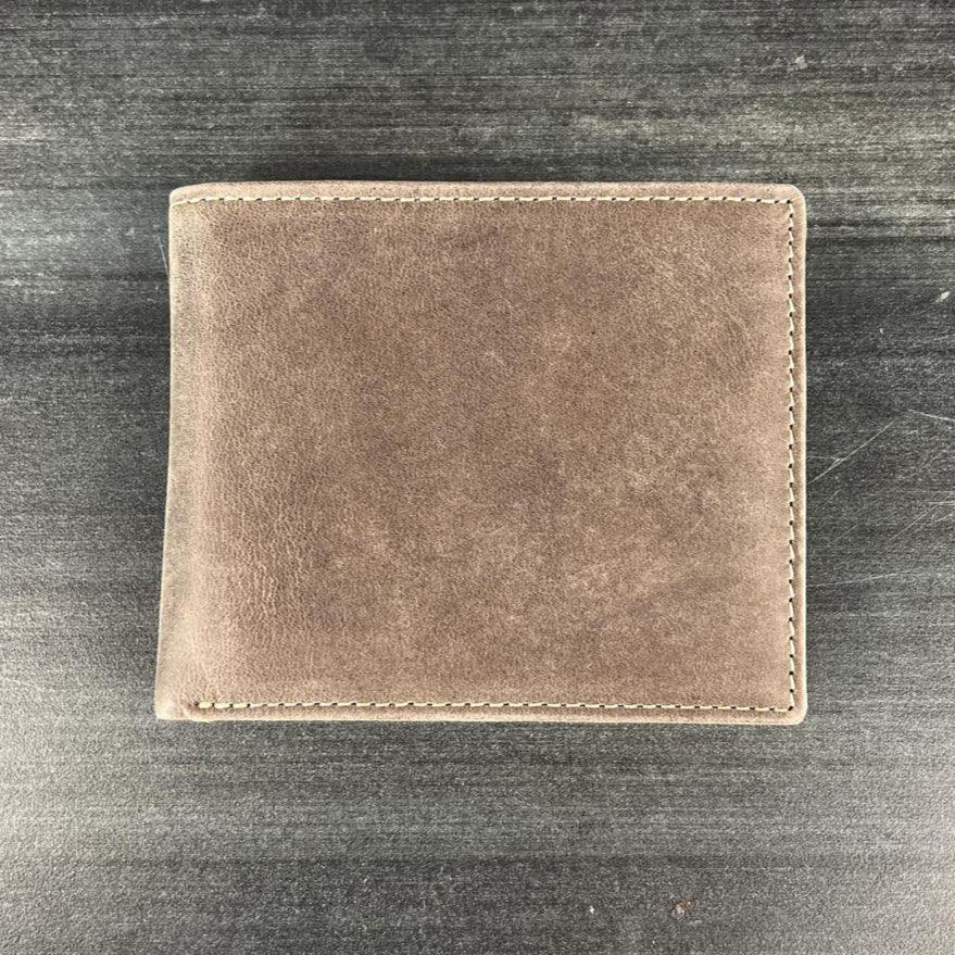 Brown leather wallet on dark wooden surface