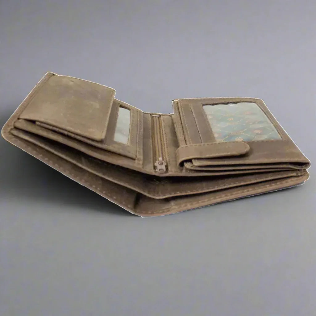 Brown canvas wallet with zipper coin pocket and clear ID window on gray background