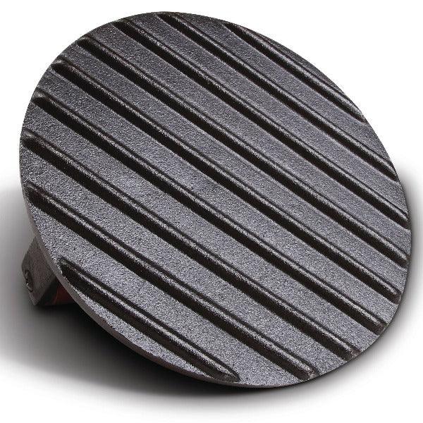 Round cast iron grill press with diagonal ridges on a white background