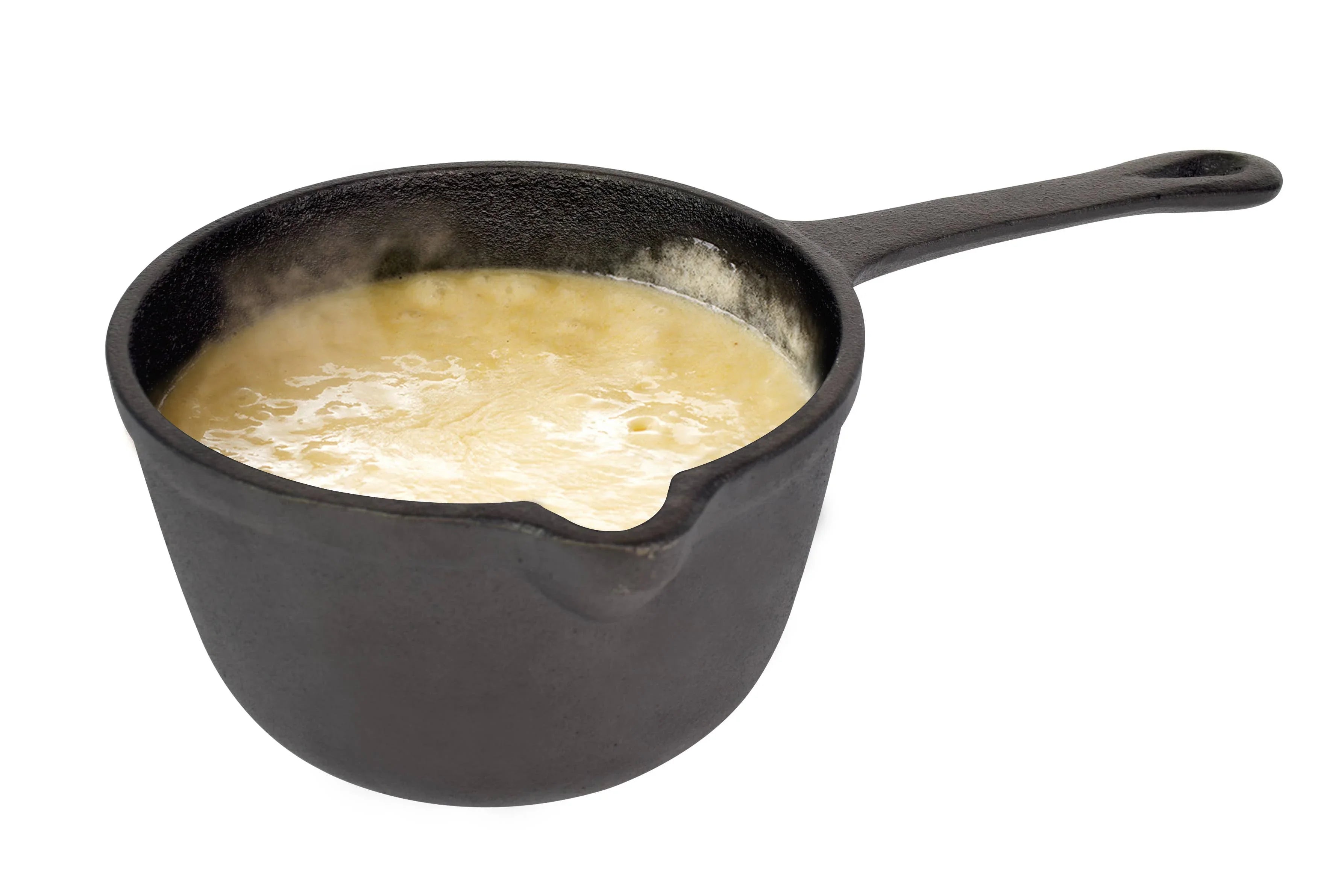 Hot creamy soup in a black cast iron saucepan on a white background