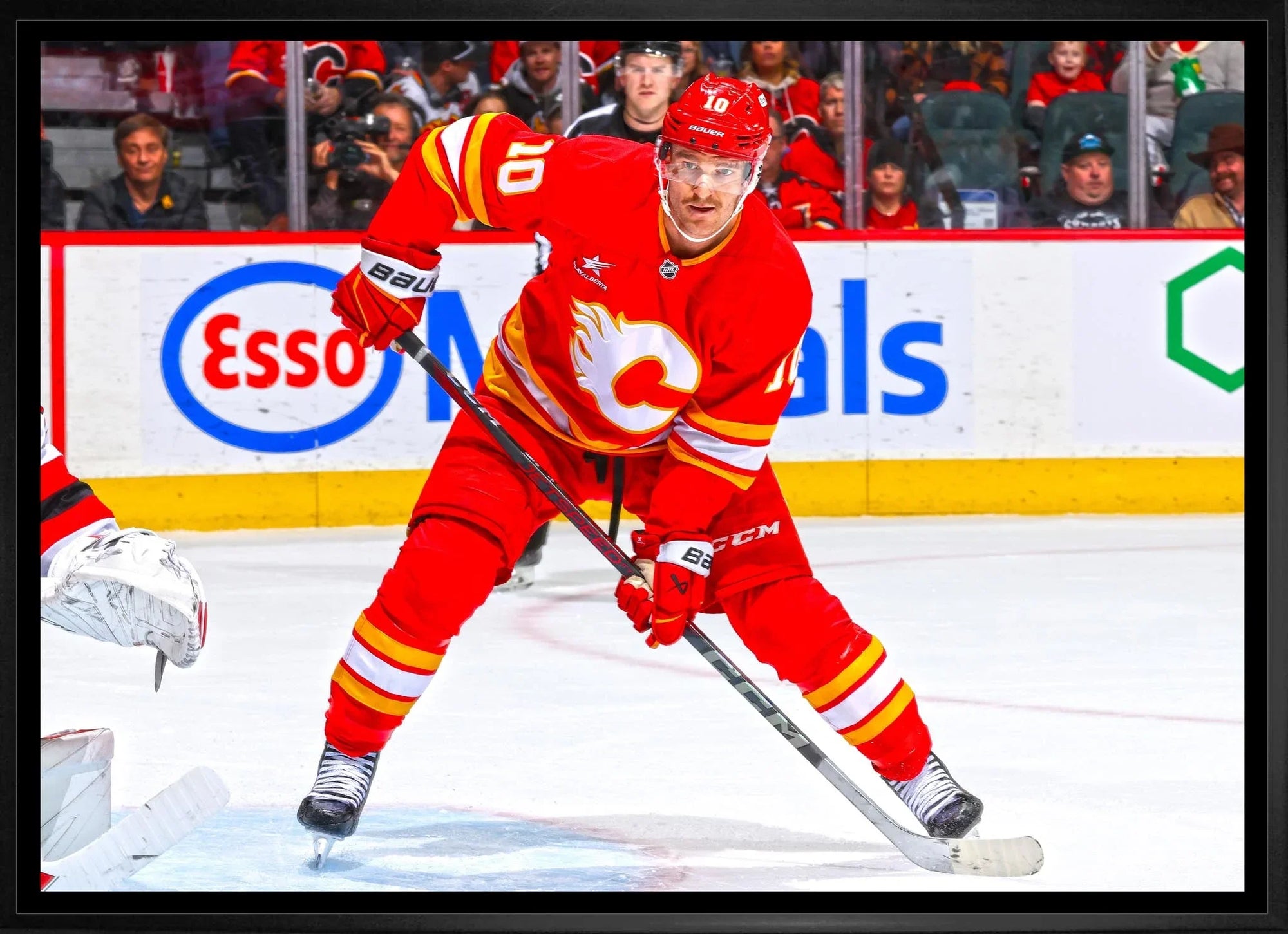 Calgary Flames hockey player in red jersey skating on ice during game action