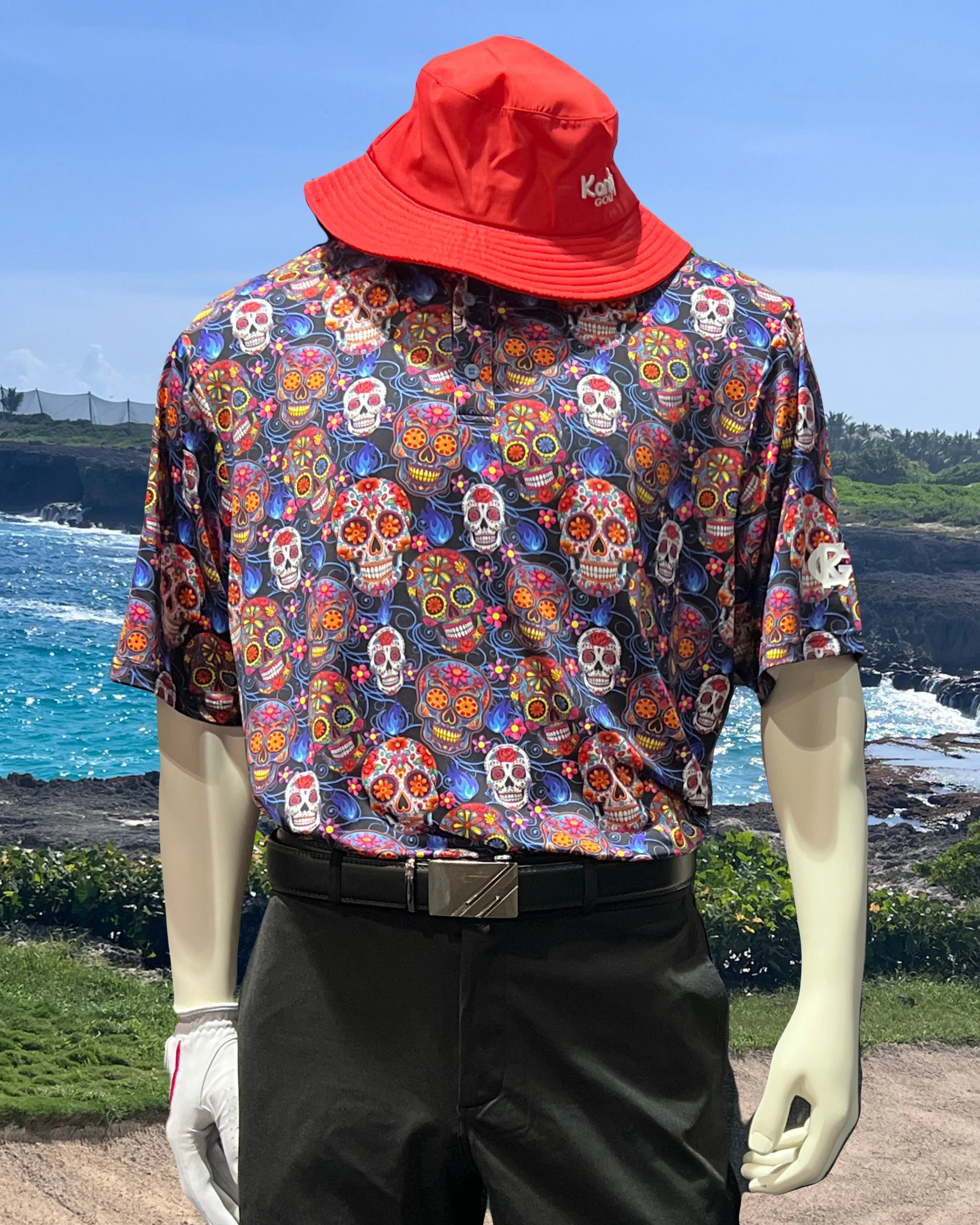 Mannequin in colorful sugar skull shirt and red bucket hat by ocean golf course