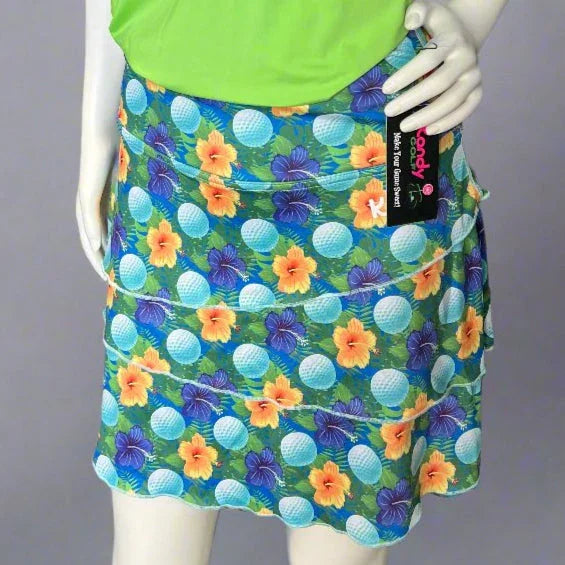 Woman's golf skort with colorful hibiscus flowers and golf balls, green top, mannequin display