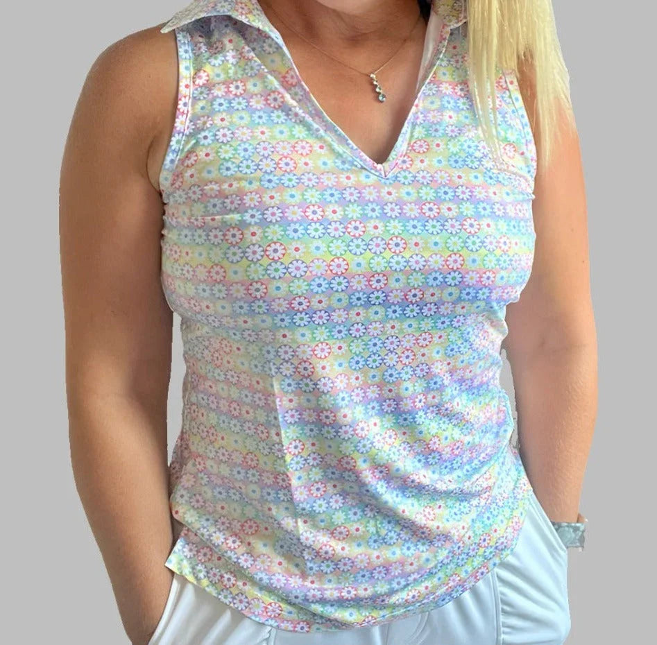 Woman wearing a sleeveless pastel floral collared golf top with daisy pattern
