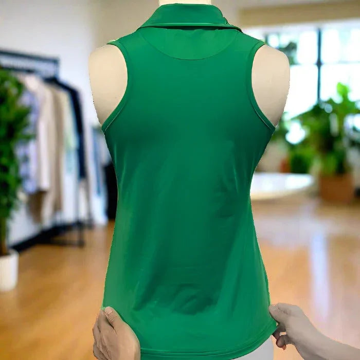 Green sleeveless polo shirt on mannequin in modern boutique with wooden floor and plants