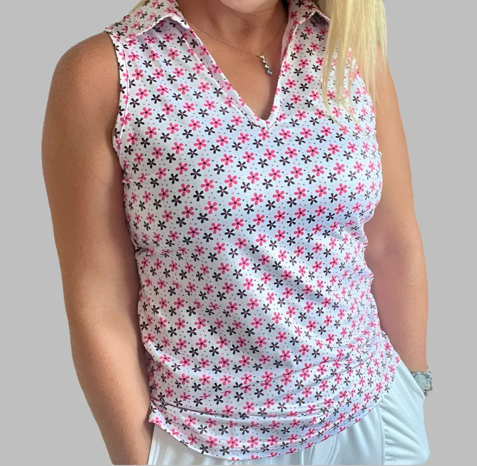 Sleeveless collared women's golf shirt with pink and black floral pattern