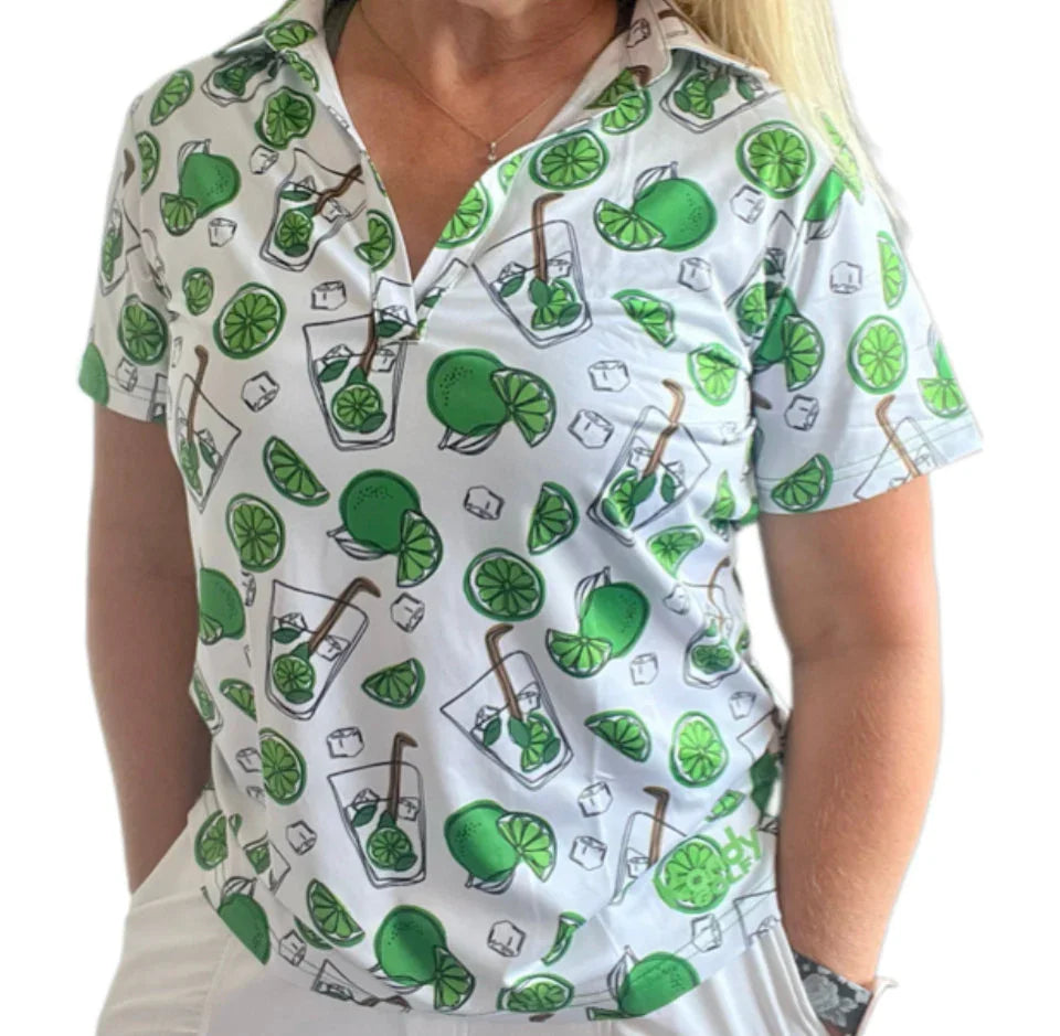 Woman wearing white polo shirt with lime and cocktail glass pattern, summer apparel