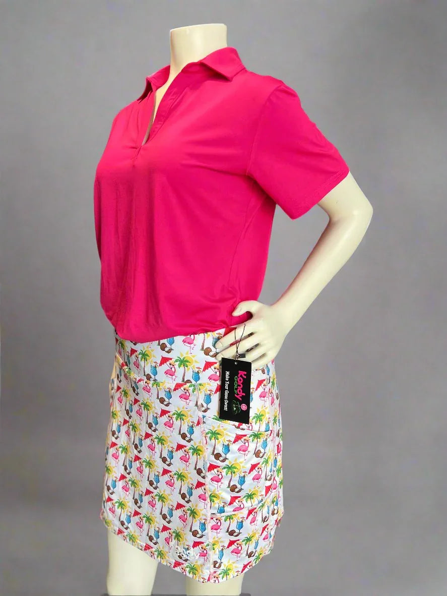 Mannequin in bright pink polo shirt and tropical flamingo print skirt, front view