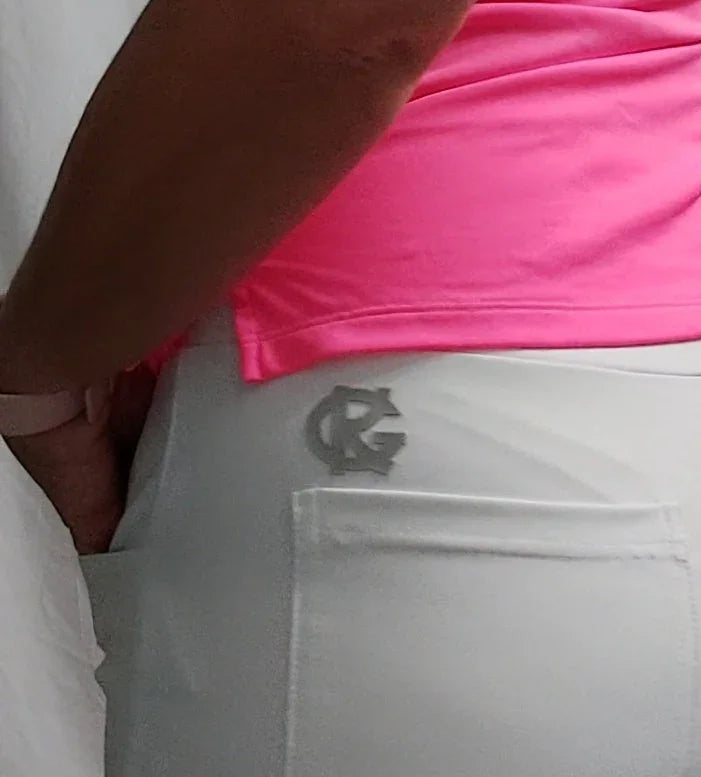 Close-up of person wearing white pants with RG logo and a bright pink shirt