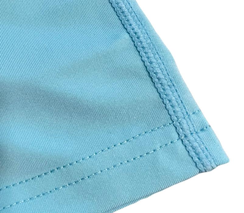 Close-up of blue fabric hem with double stitching detail