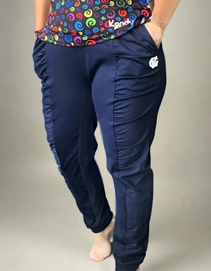 Navy blue jogger pants with side logo, paired with colorful swirl print top