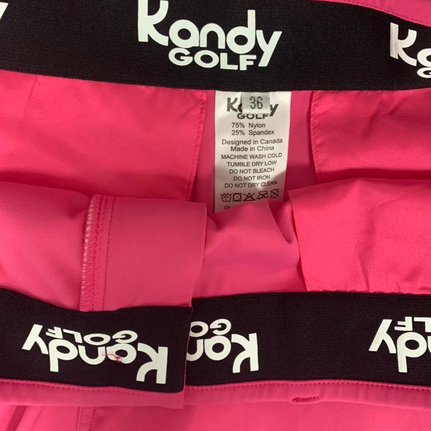 Kandy Golf pink shorts waistband with logo and clothing tag, nylon spandex blend