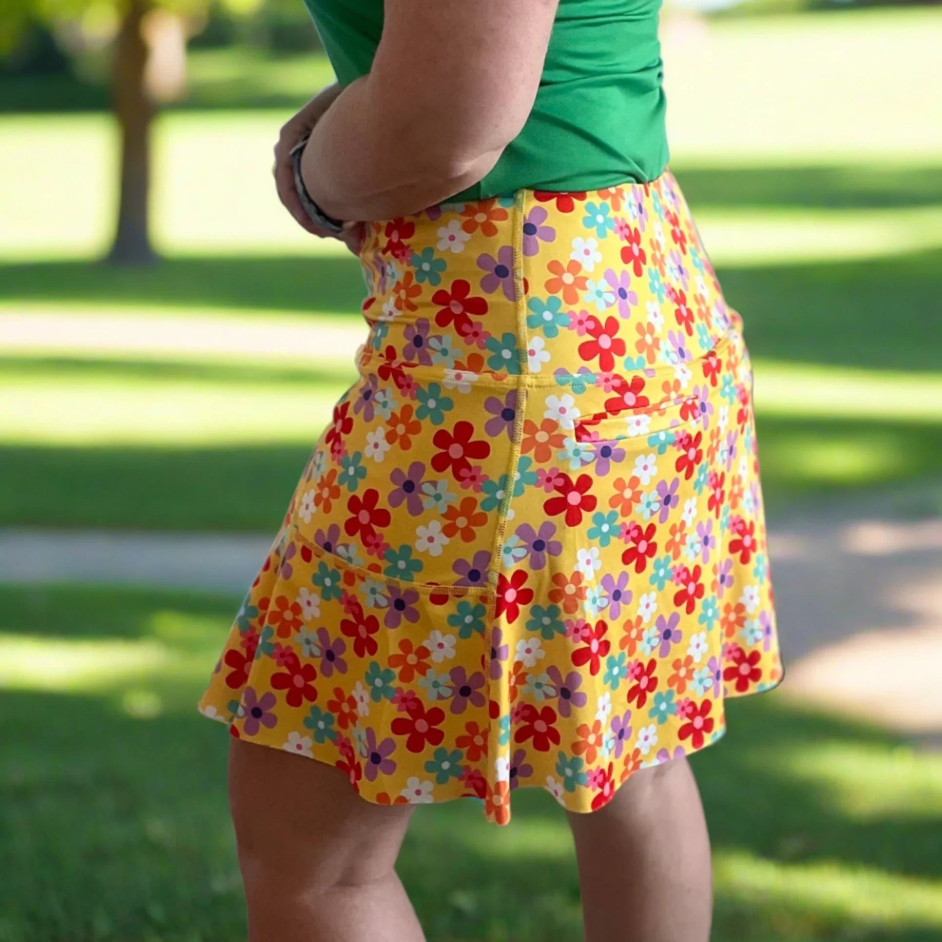 Yellow floral skirt with colorful flower print worn outdoors in sunny park