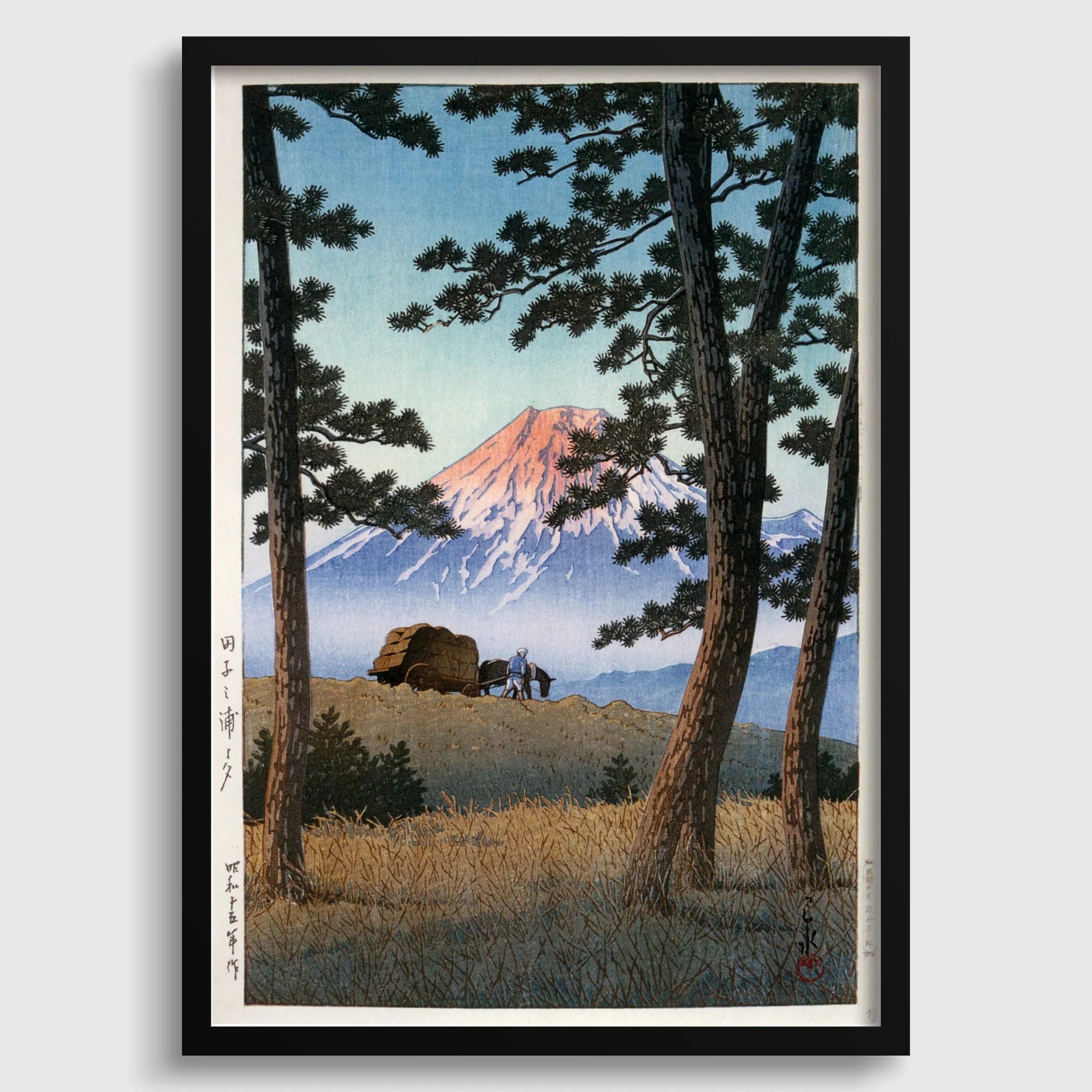 Framed Japanese woodblock print of Mount Fuji at sunset with trees and farmers in the foreground