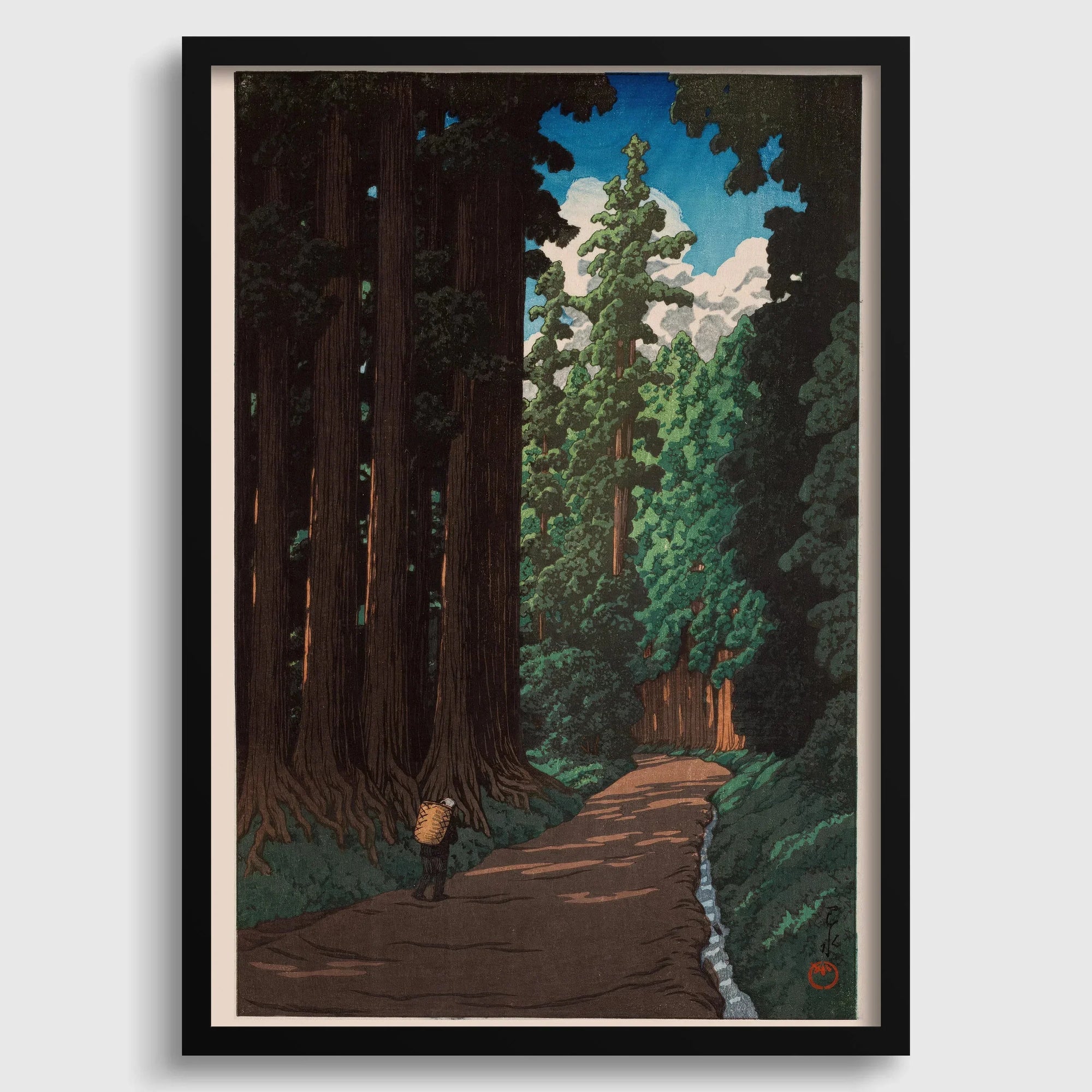 Japanese woodblock art print of a forest road with tall trees and a lone traveler