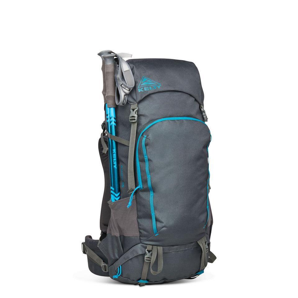 Kelty Asher 55 hiking backpack in gray with blue trim, trekking poles attached
