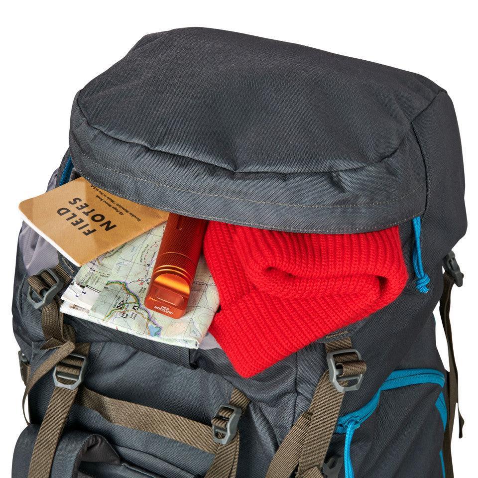 Kelty Asher 55 backpack with red sweater, field notes, map, and bottle in top pocket