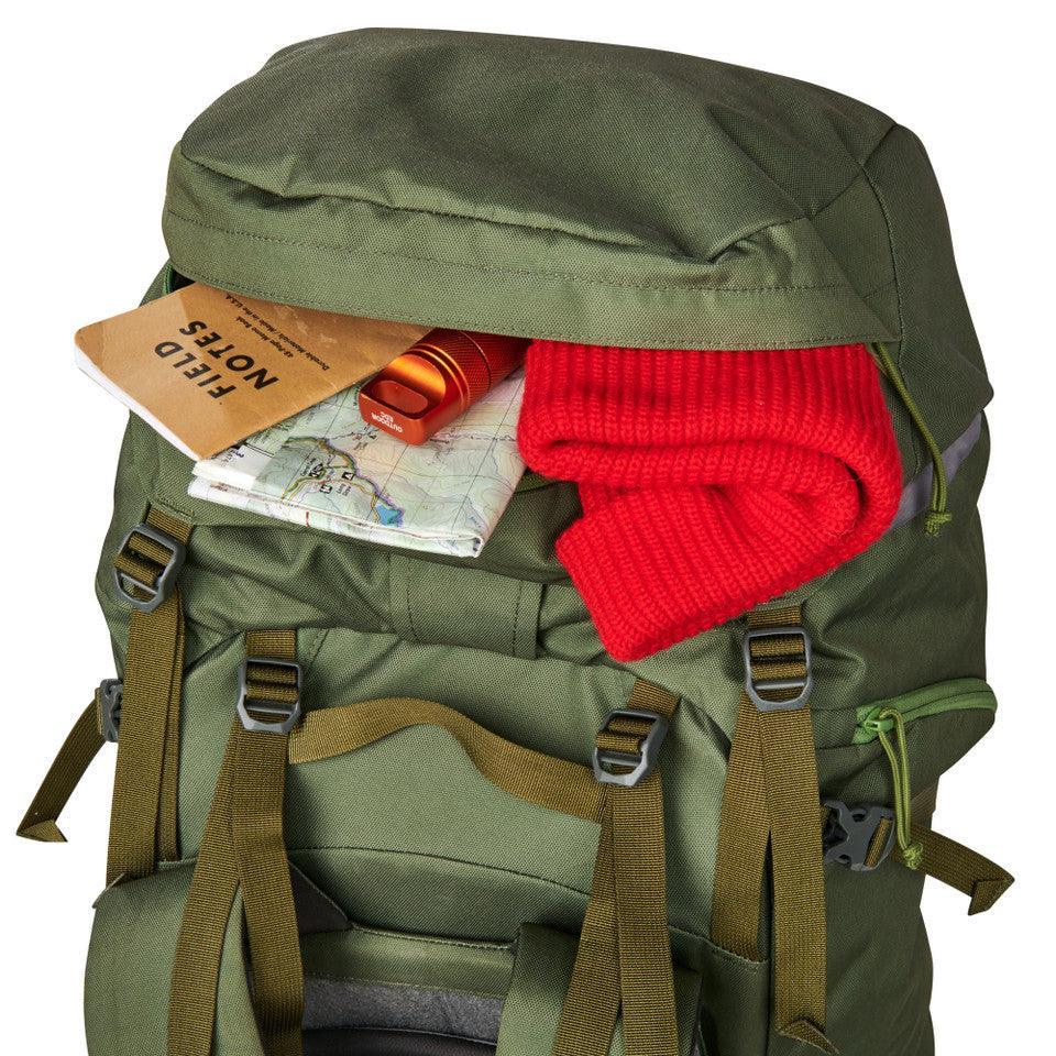 Olive green Kelty Asher 85 backpack with field notes, map, red knit hat, and gear inside top lid