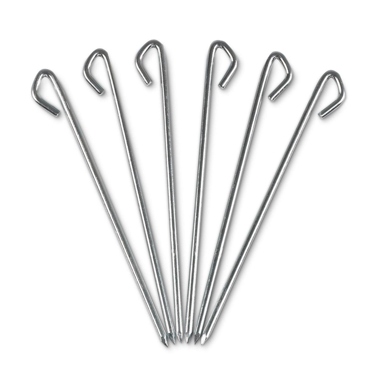 Set of six silver metal tent stakes with hooked tops on a white background
