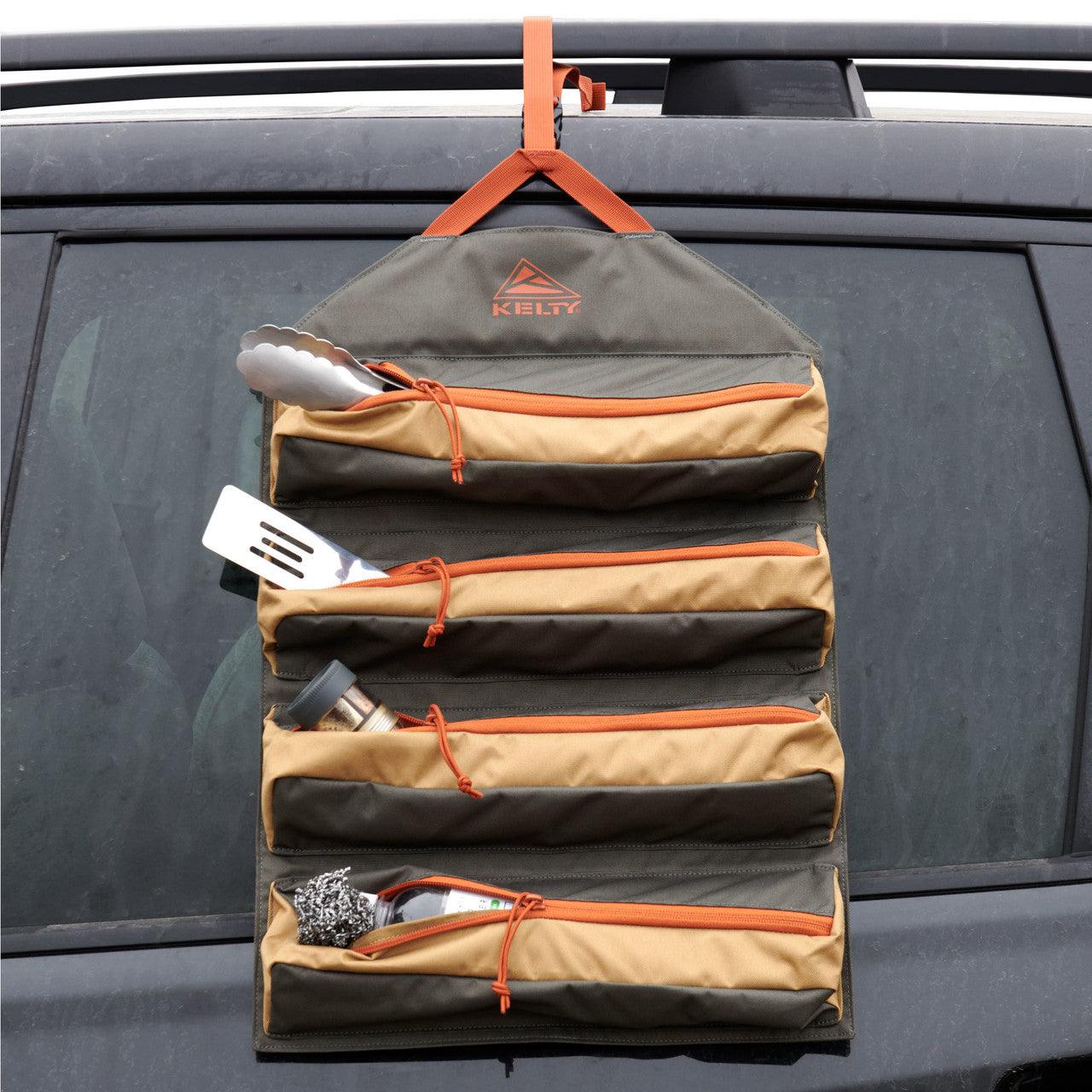 Kelty hanging camping kitchen organizer with utensils attached to a car window