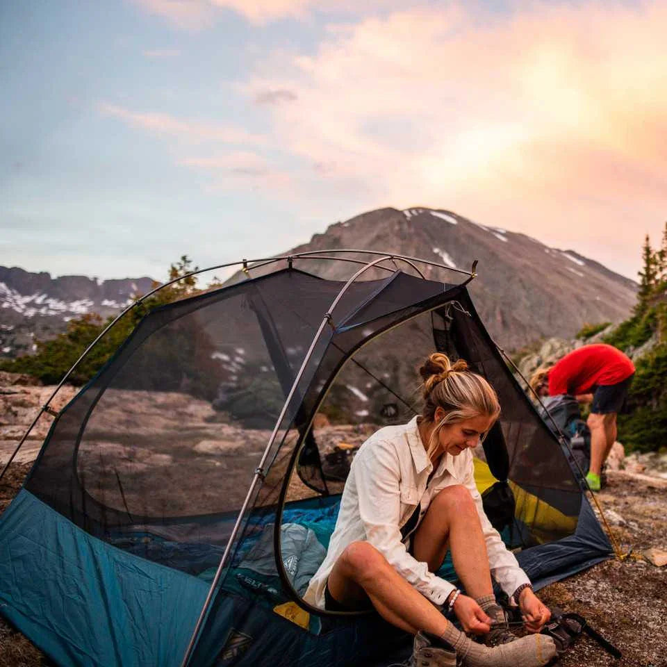 Kelty Far Out 2 tent with footprint in mountain landscape at sunset, campers outside