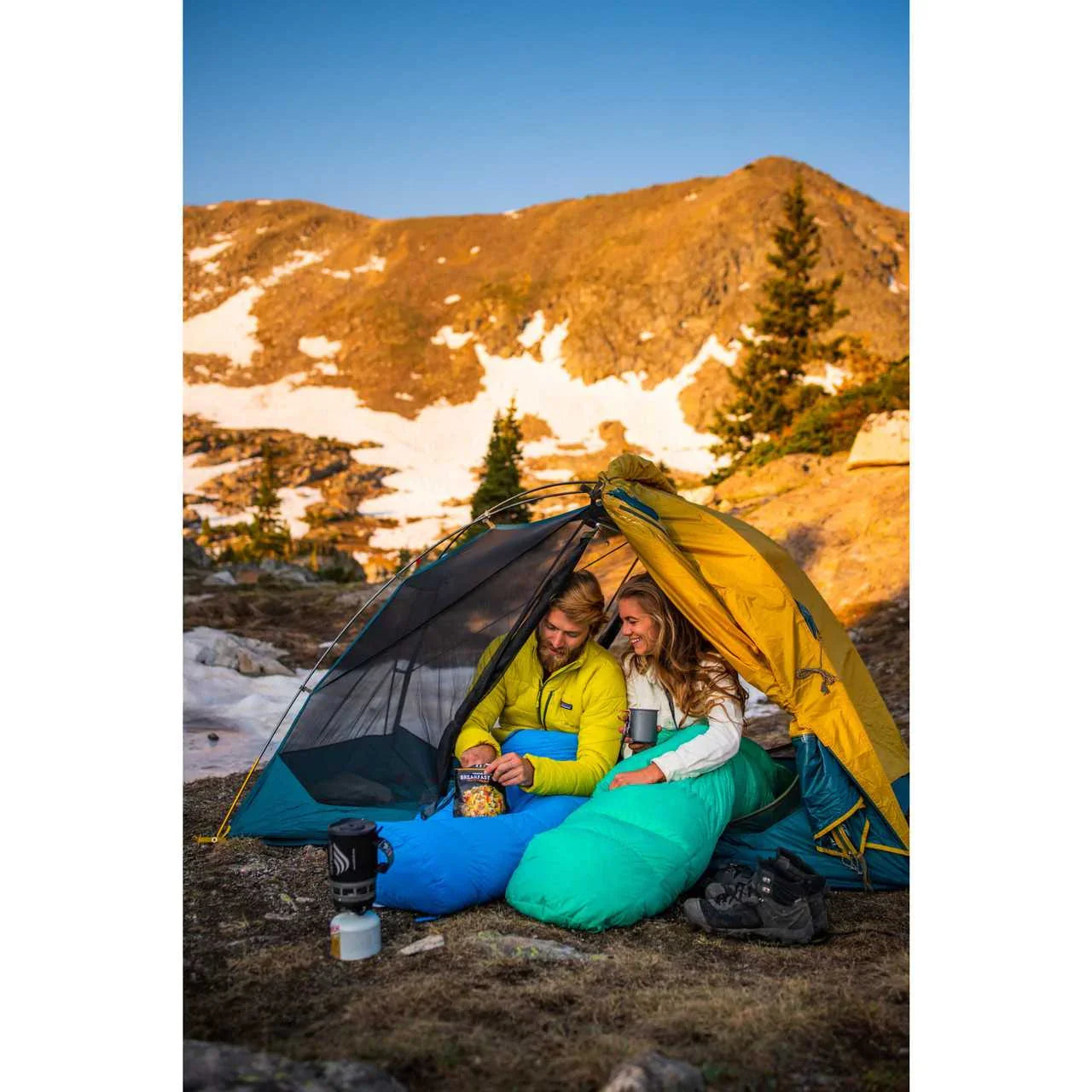 Couple camping in Kelty Far Out 2 tent with footprint, mountain view, snow patches