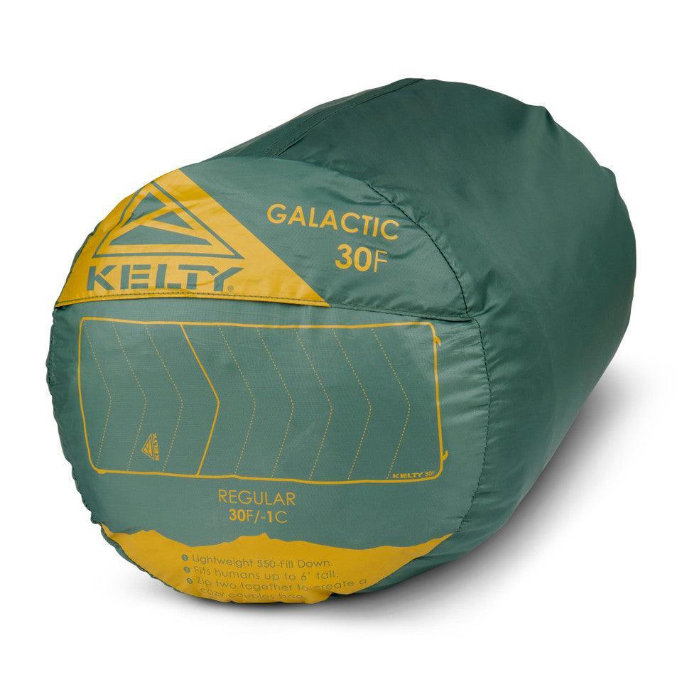 Kelty Galactic 30F regular green sleeping bag tightly packed with yellow branding