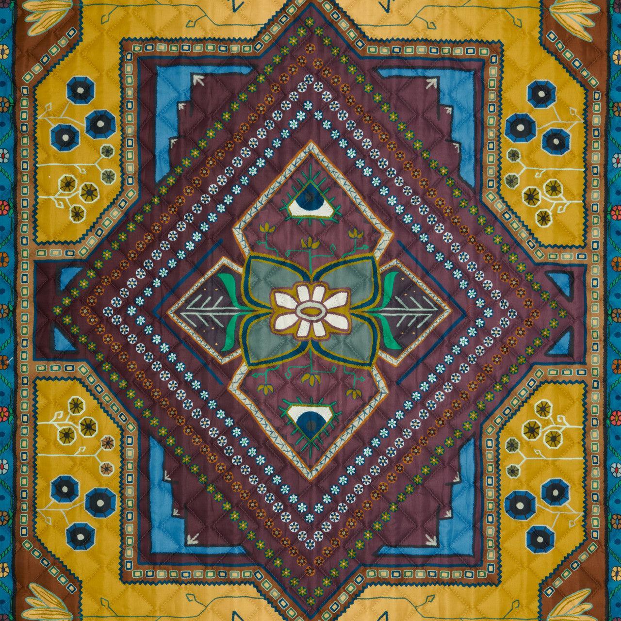 Colonial blue geometric quilt blanket with floral and diamond pattern detailing