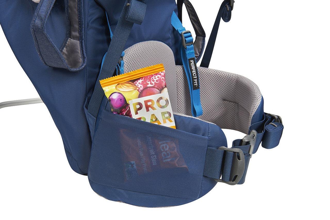 Navy hiking backpack waist belt pocket holding PROBAR snack, PerfectFIT strap visible.