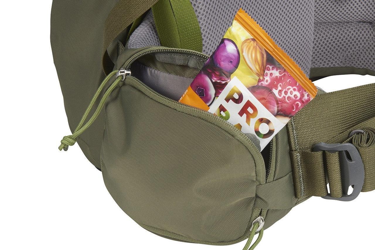 Green hiking waist pack with mesh padding and a snack bar in the zippered pocket