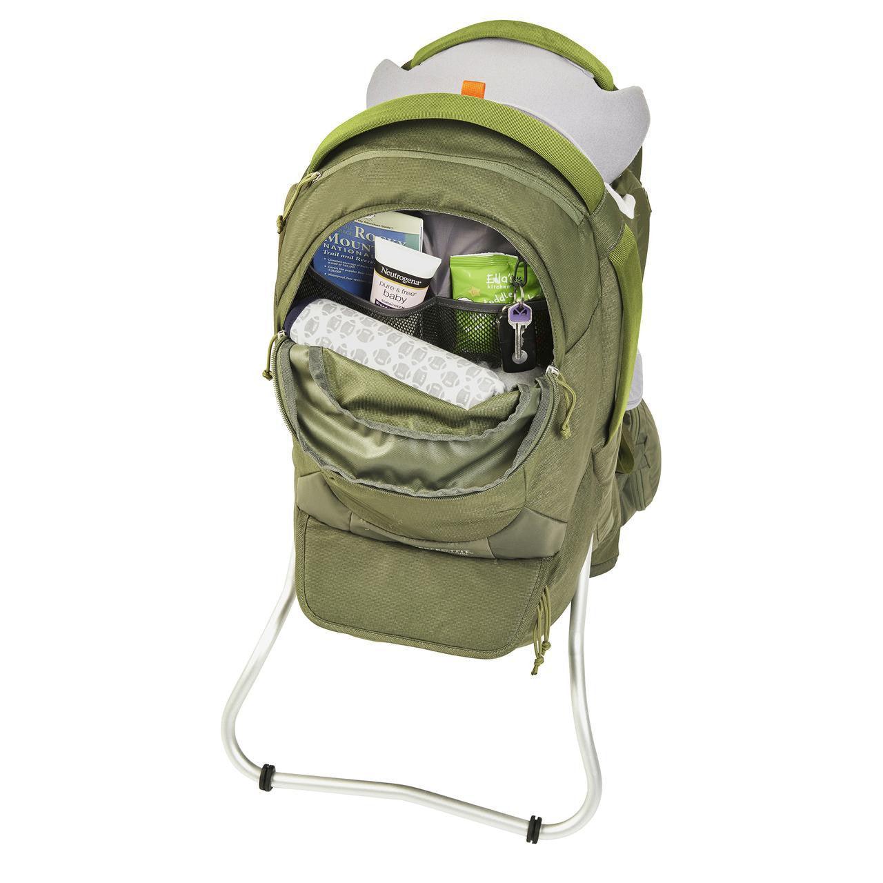 Green hiking backpack with open back pocket showing organized baby essentials and travel items