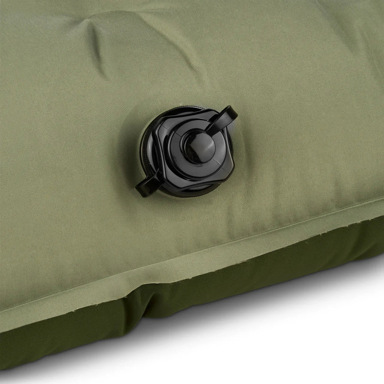 Close-up of green inflatable camping mattress with black air valve
