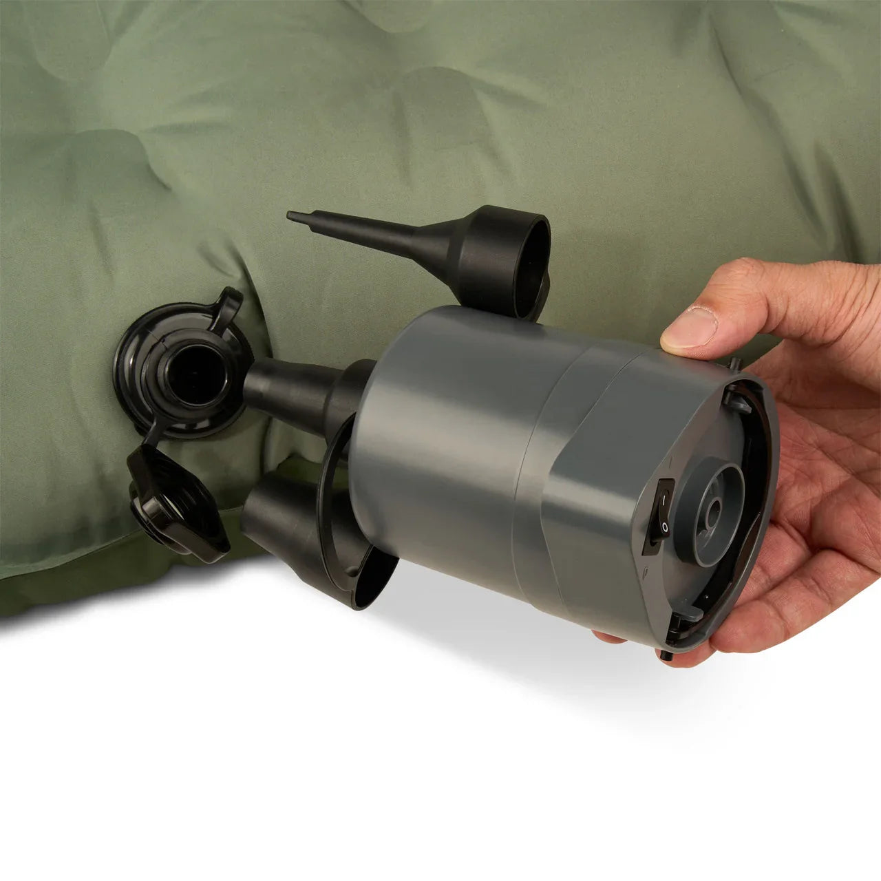 Portable electric air pump inflating green air mattress with nozzle attachment