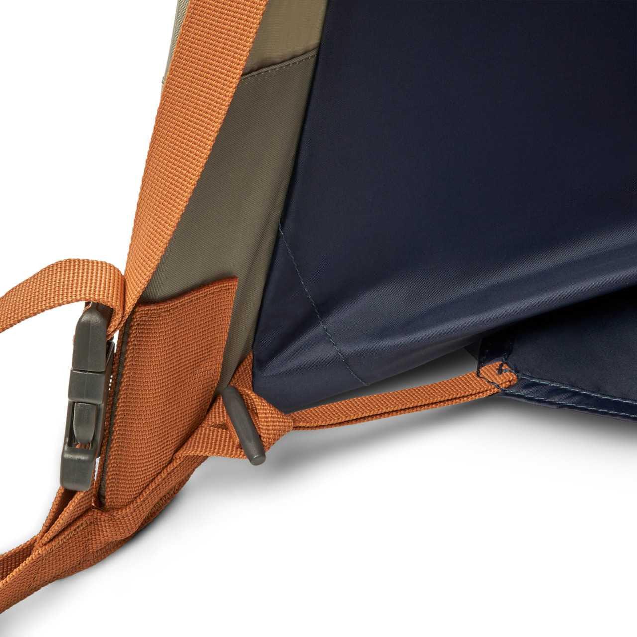 Kelty Late Start 2P tent corner with orange straps, metal buckle, and blue fabric floor