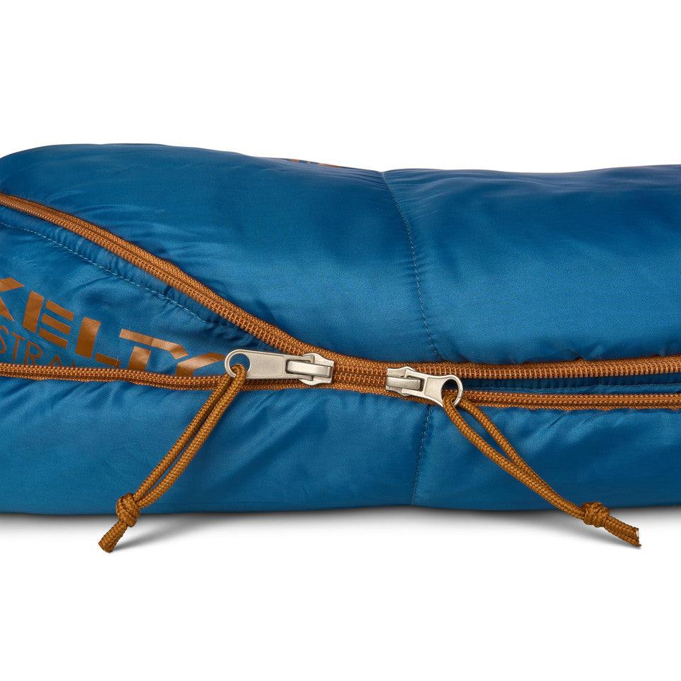 Blue Kelty sleeping bag with orange zipper pulls and double zipper detail