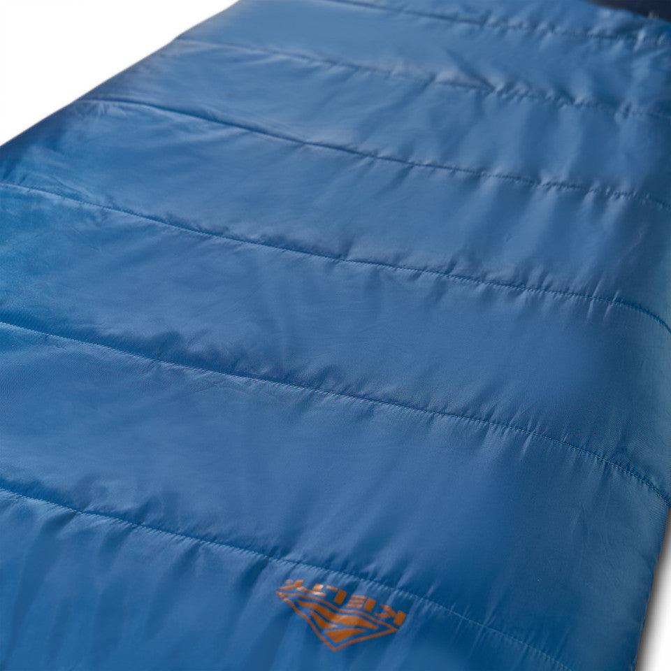 Blue sleeping bag with orange logo and stitched seams, outdoor camping gear