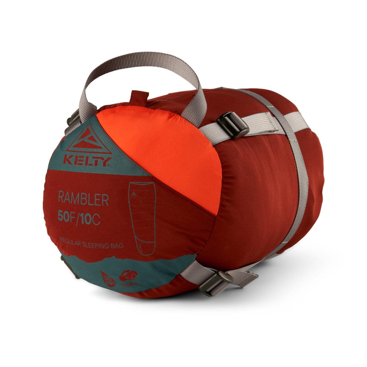 Kelty Rambler 50F/10C regular sleeping bag packed in red stuff sack with gray straps