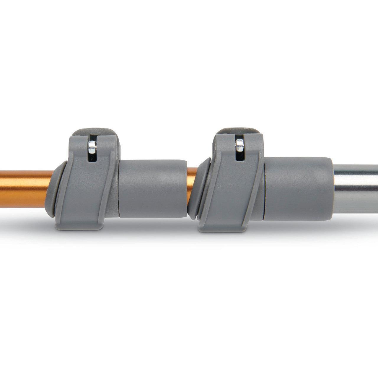 Close-up of Kelty Scree trekking poles with gray locking mechanisms on orange and silver shafts