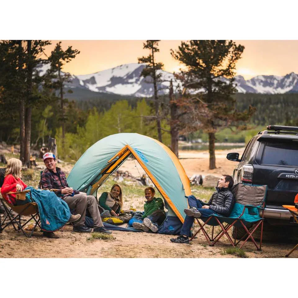 Family camping with Kelty Wireless 2 tent at sunset near mountains, forest, and SUV