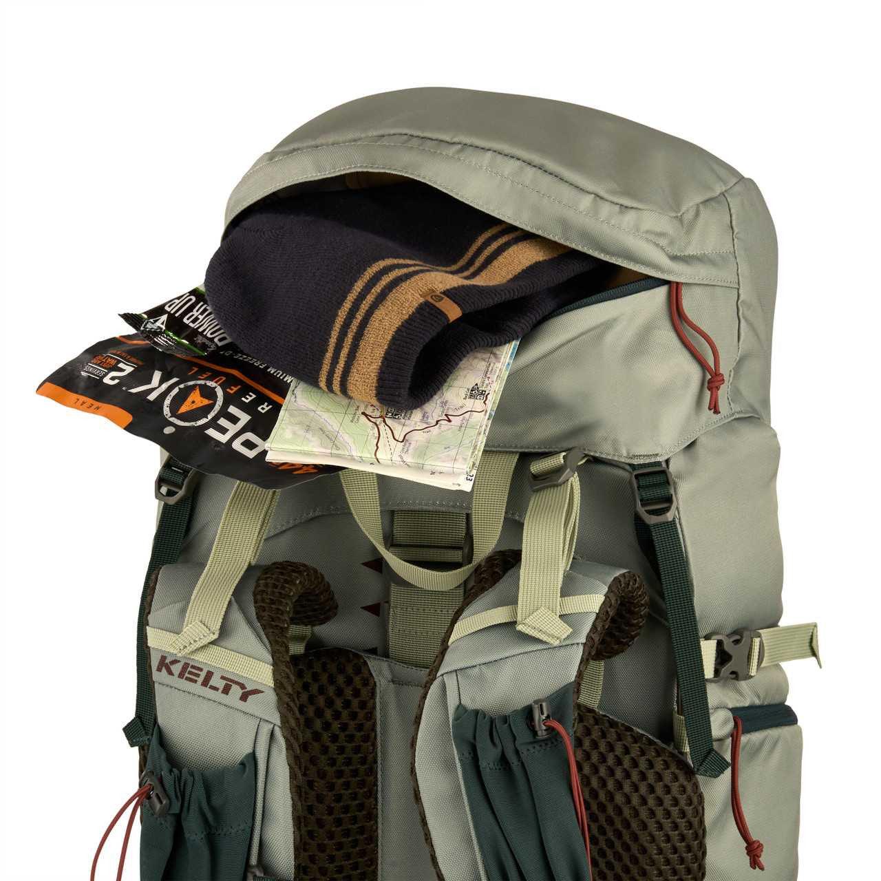 Kelty Women's Glendale 65L hiking backpack with open pocket showing map and beanie