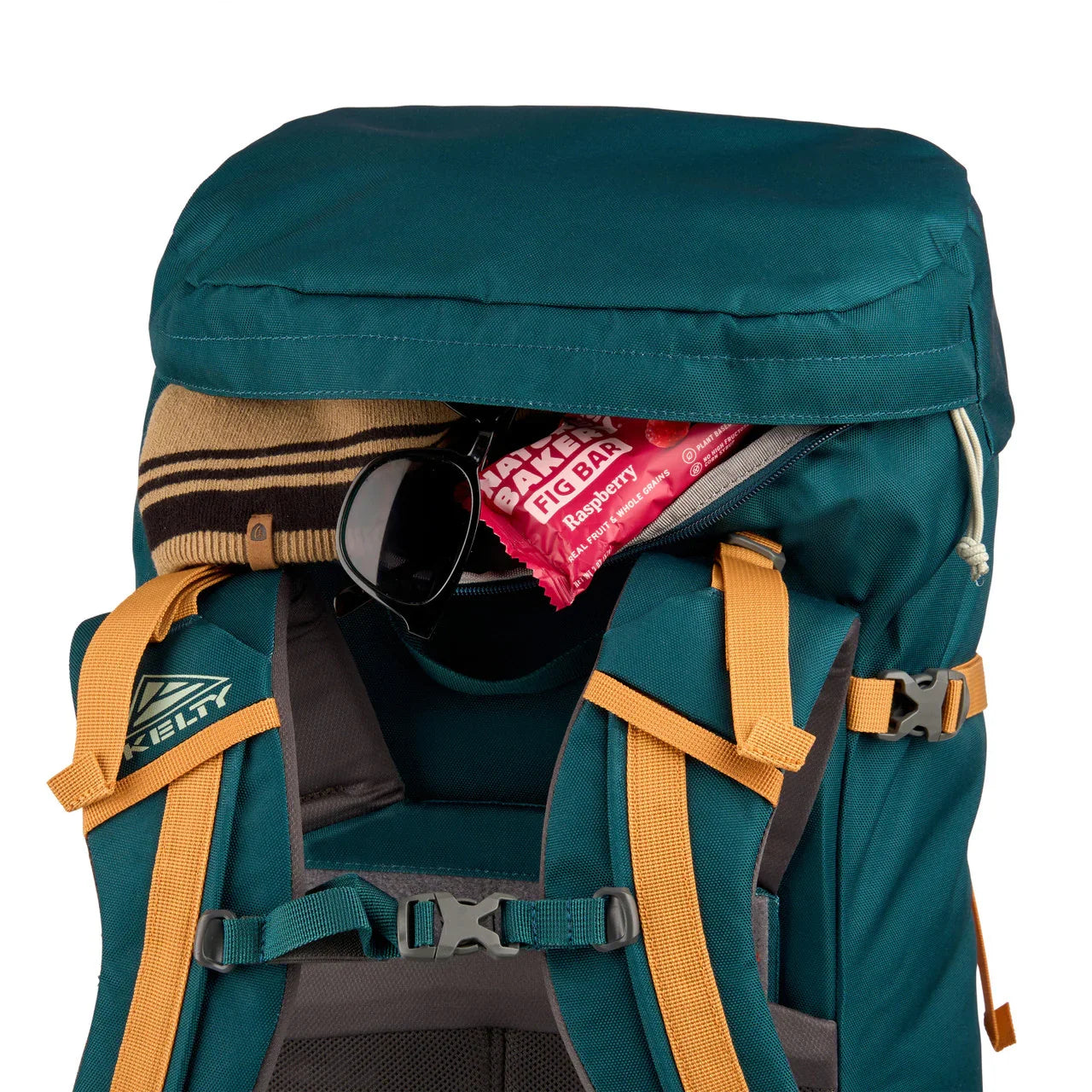 Kelty Nena 65L teal hiking backpack with sunglasses, a striped beanie, and fig bar in pocket