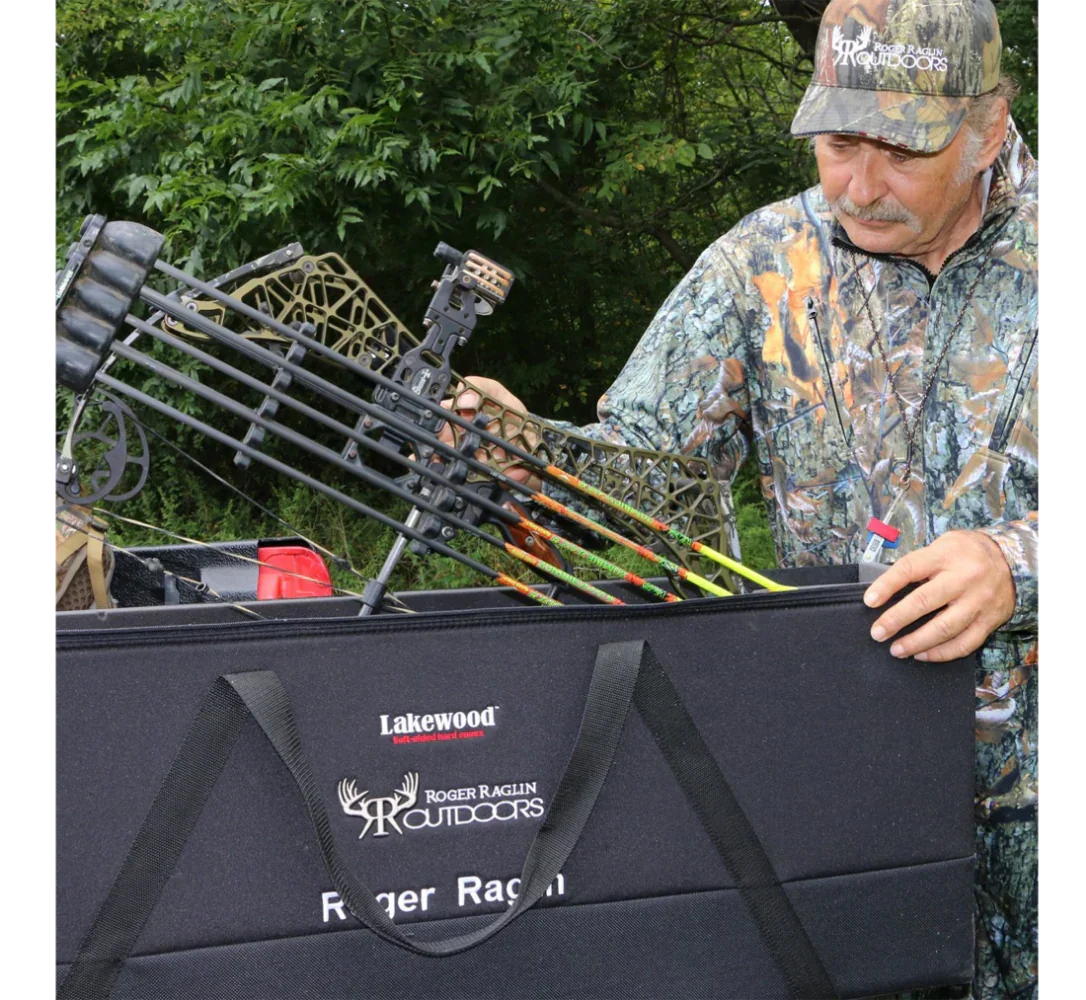 Hunter in camo gear loading compound bow into Lakewood Roger Raglin Outdoors case outdoors